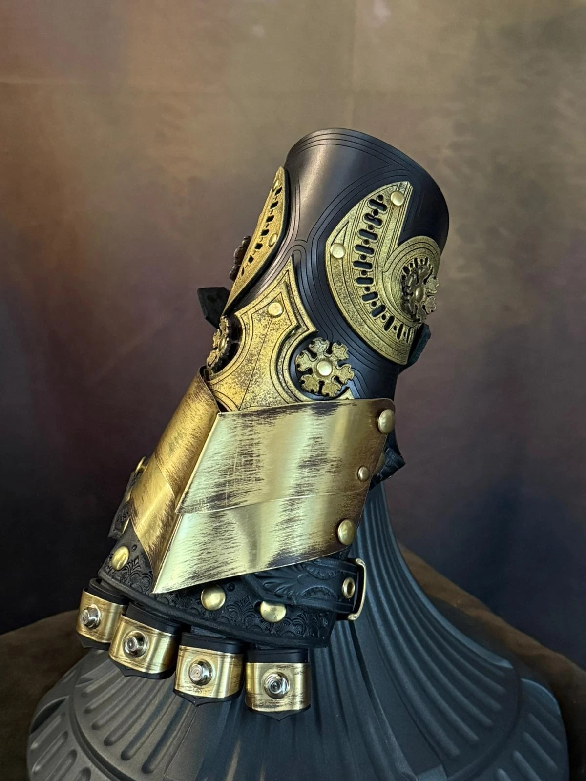 Baroque steampunk gauntlet in brass and leather with ornate decorations