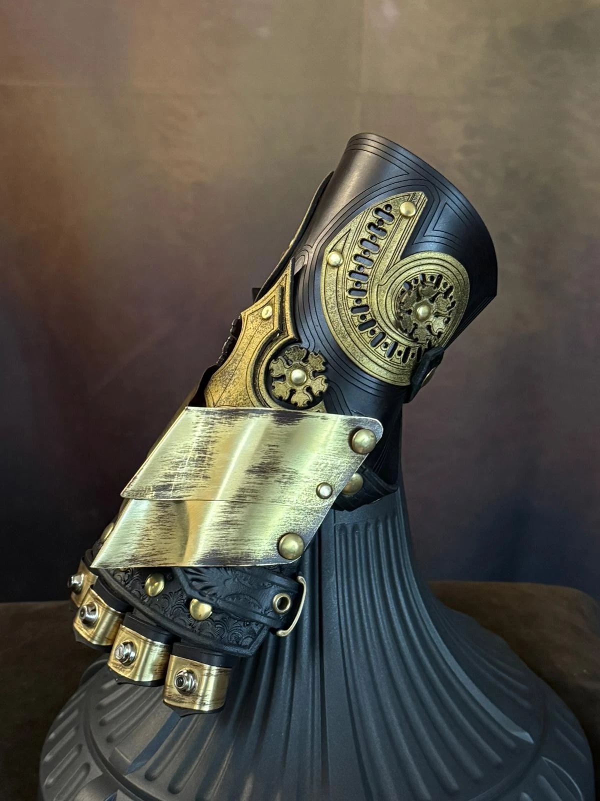 Baroque steampunk gauntlet in brass and leather with ornate decorations